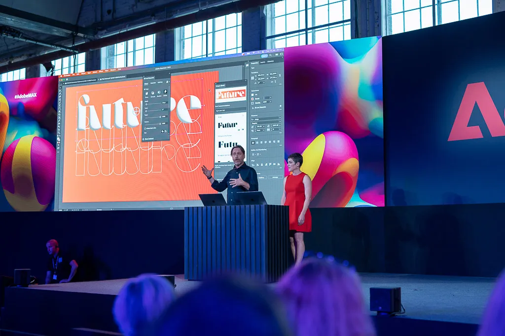 Speaker on stage presenting a software demonstration