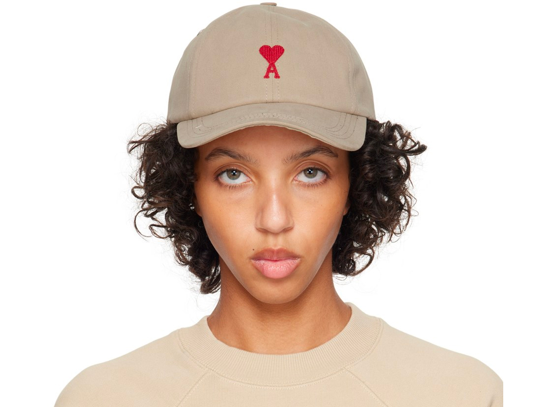 A tan hat, with a heart embrioidered on.