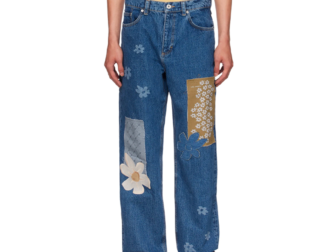 blue jeans with various patches and sewn objects