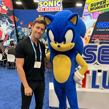 A fan taking a photo with someone in a Sonic the hedgehog suit