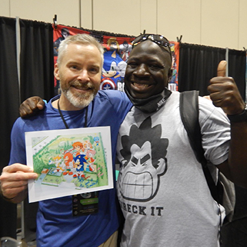 A fan taking a photo with Roger Craig Smith, the voice of Sonic the Hedgehog