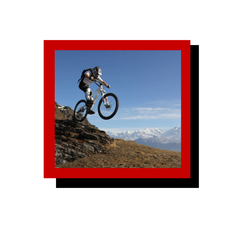 Image of a mountain biker jumping a cliff.