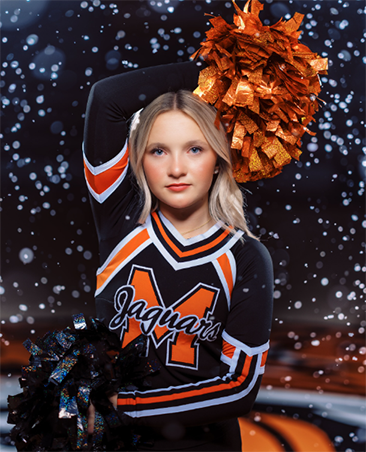 A high school cheerleader with one arm above her head, one arm across her waist, holding pom-poms, with a snowy backdrop.