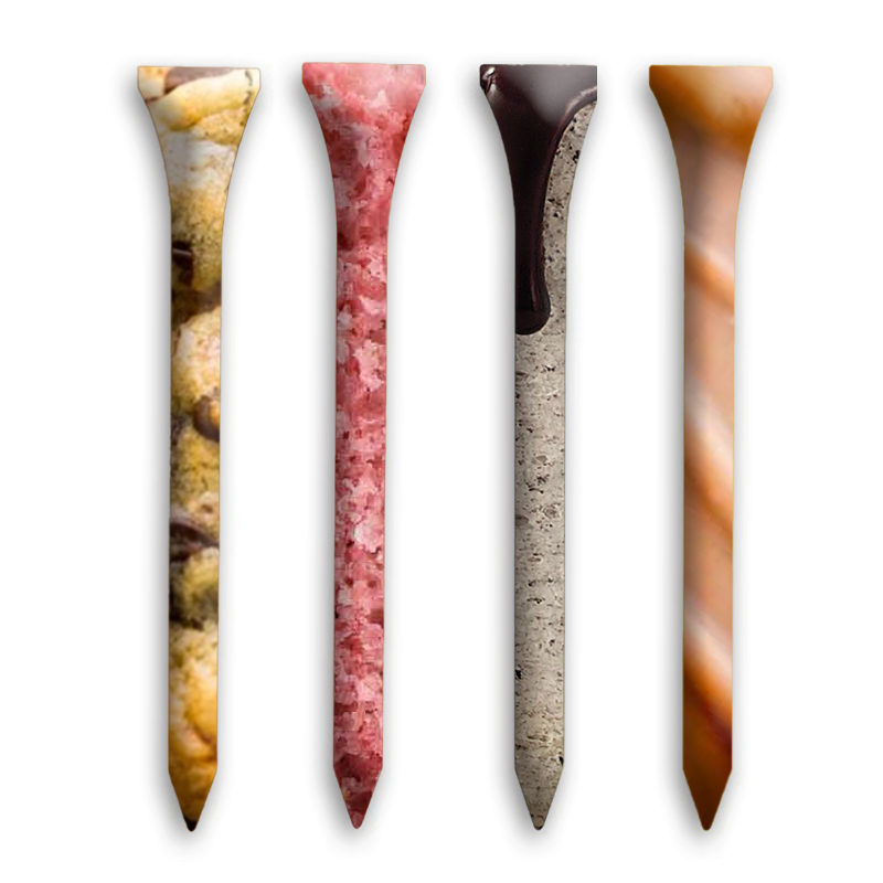 A row of four golf tees, but they do not look like normal golf tees. Each one is edited in Photoshop, overlayed with an image of food. Each one is a different flavor: one chocolate-chip cookie, one strawberry cake, one cookie-and-cream, and one caramel.